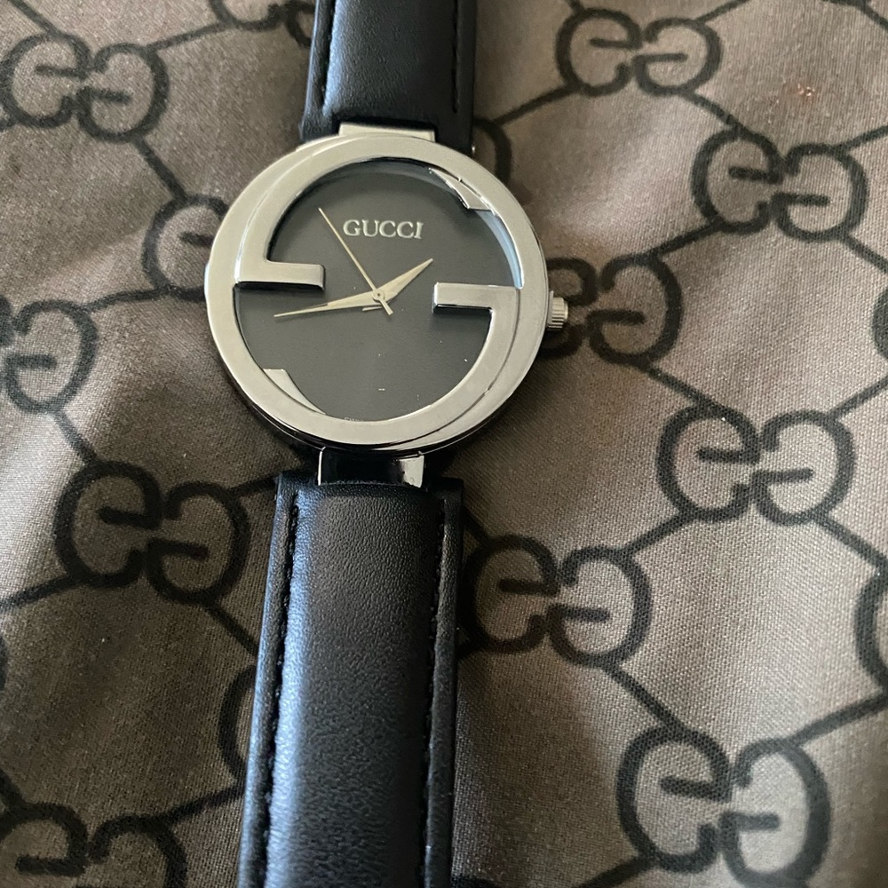 Beautiful black and silver Gucci never worn sleek black leather sturdy band.